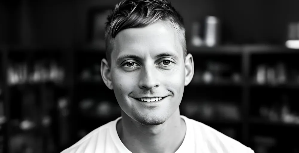 Jerad Raines, smiling, in black and white